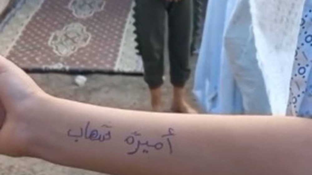 Palestinos anotam nomes nos braços para identificar mortos por ataques